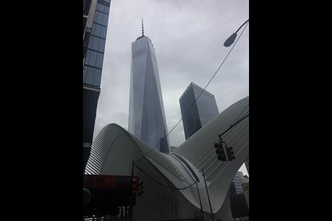 One World Trade Center or Freedom Tower, the main building of the rebuilt complex, towers behind the mall's Oculus.